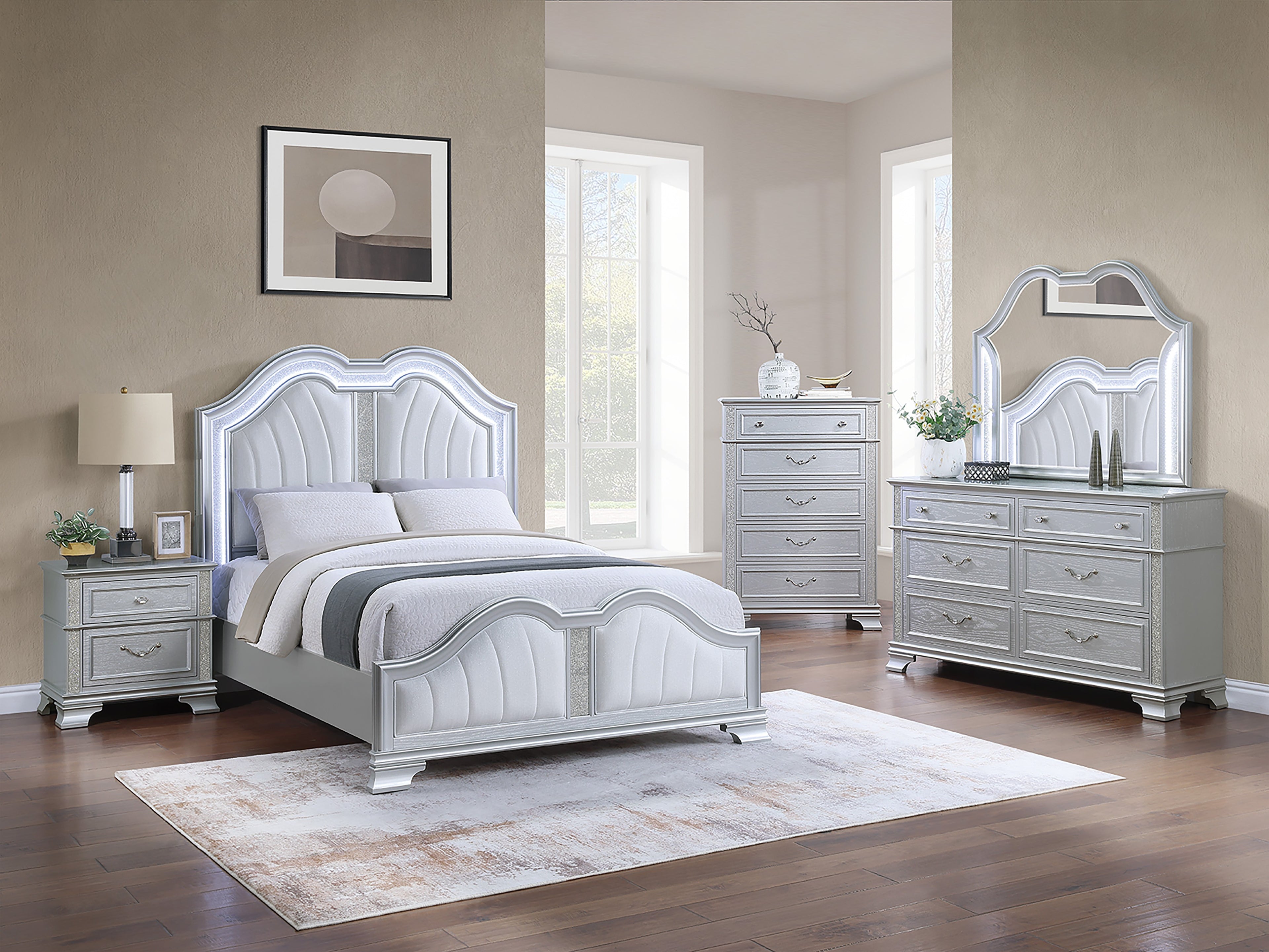 Gray bedroom set with bed, dresser, and mirror in a room with large windows.