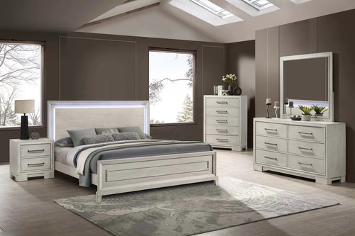 Neatly arranged bedroom with a bed, nightstands, dresser, and mirror.