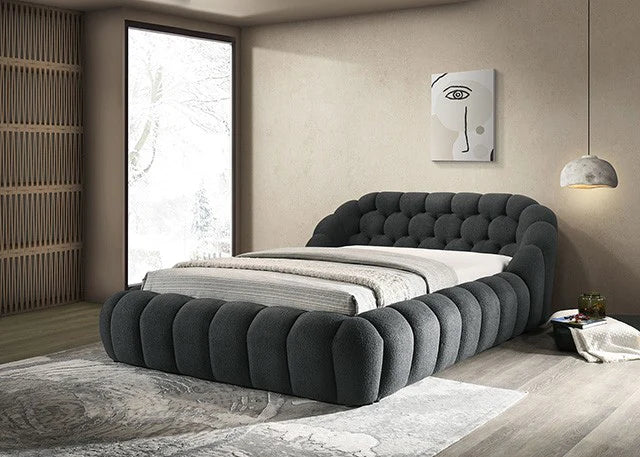 Modern bedroom with a gray upholstered bed, large window, and abstract wall art.