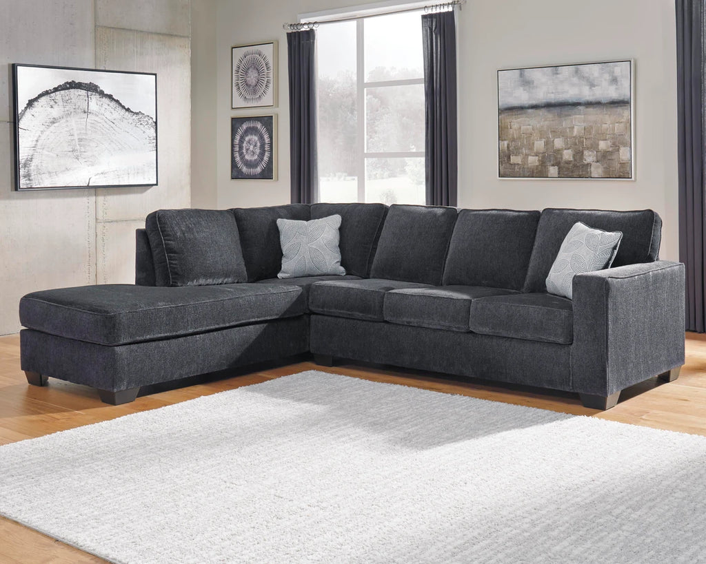 Gray sectional sofa in a living room with decor elements.