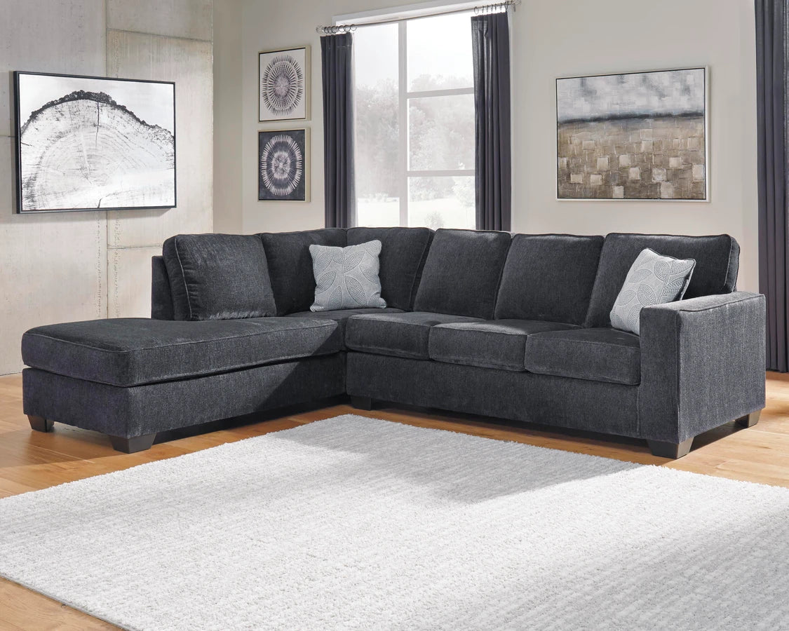 Gray sectional sofa in a living room with decor elements.