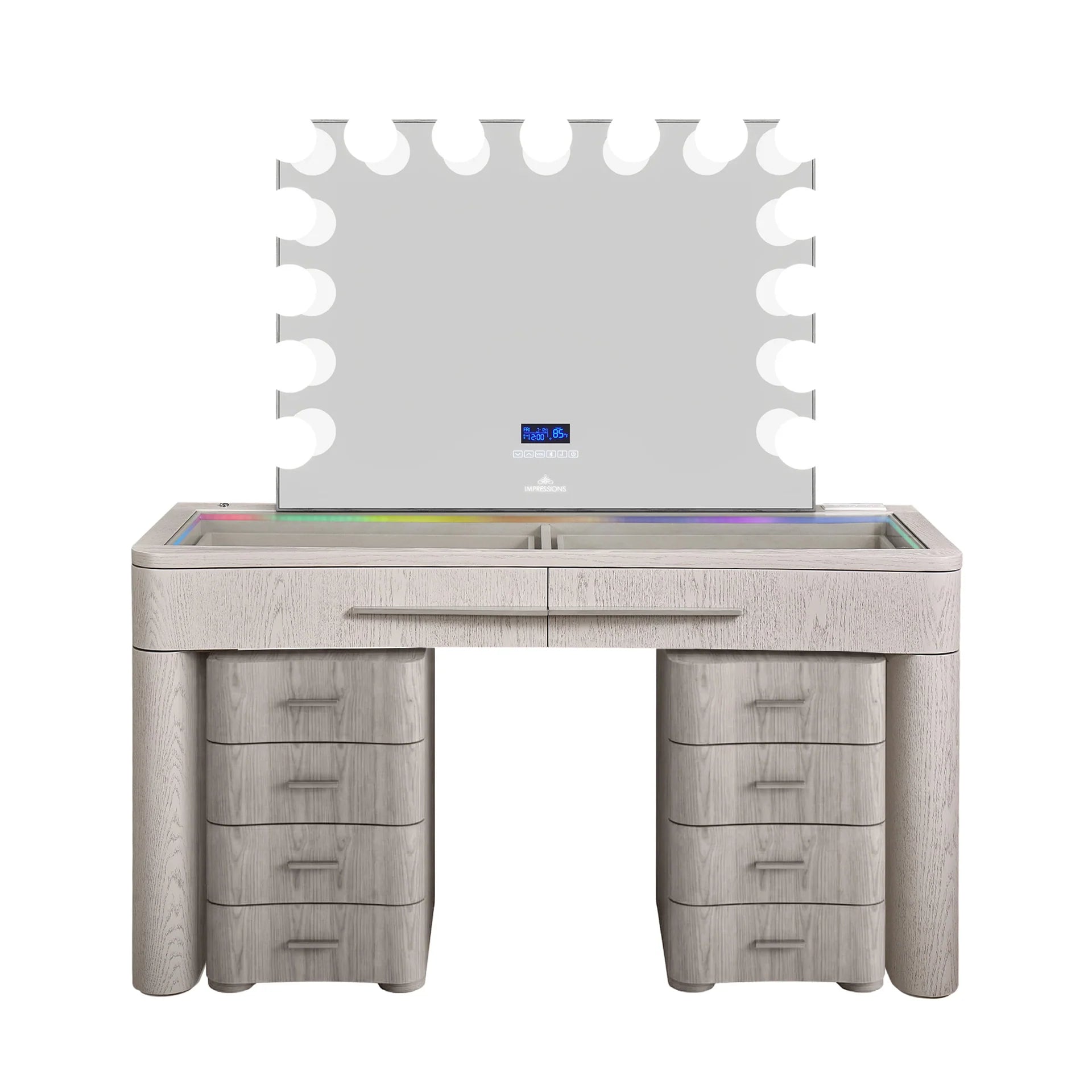 Modern white wood makeup vanity with RGB LED lighting, large Hollywood-style mirror with globe bulbs, glass top surface, and matching drawer storage stools in a white back setting.