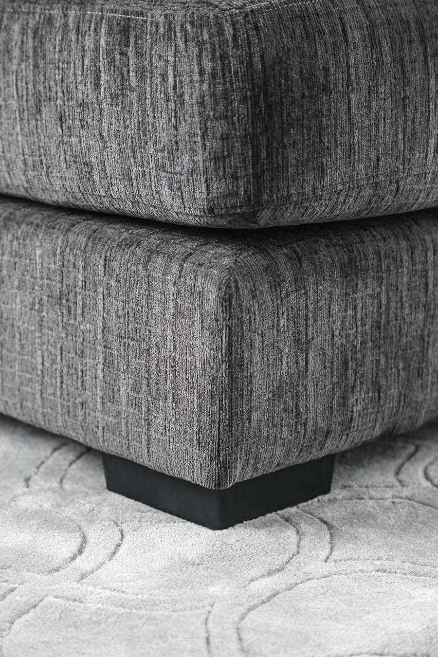 Gray textured sofa on a patterned rug