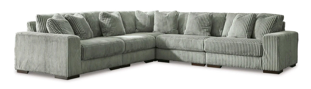 Gray sectional sofa with patterned cushions on a white background