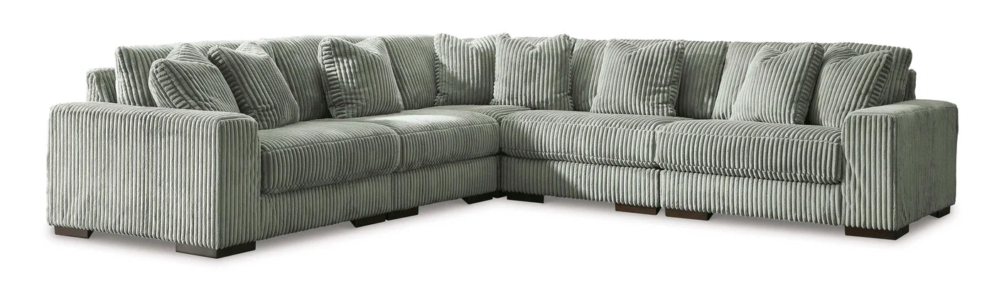 Gray sectional sofa with patterned cushions on a white background