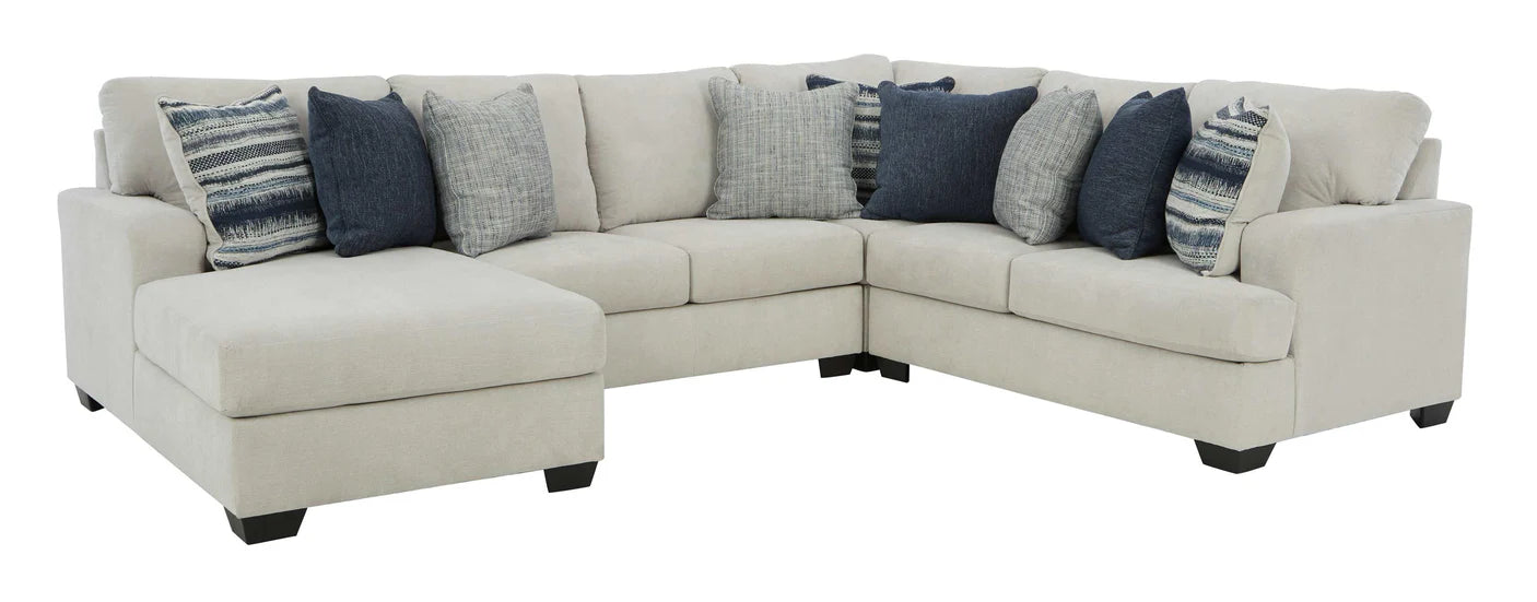 White sectional sofa with patterned cushions on a white background