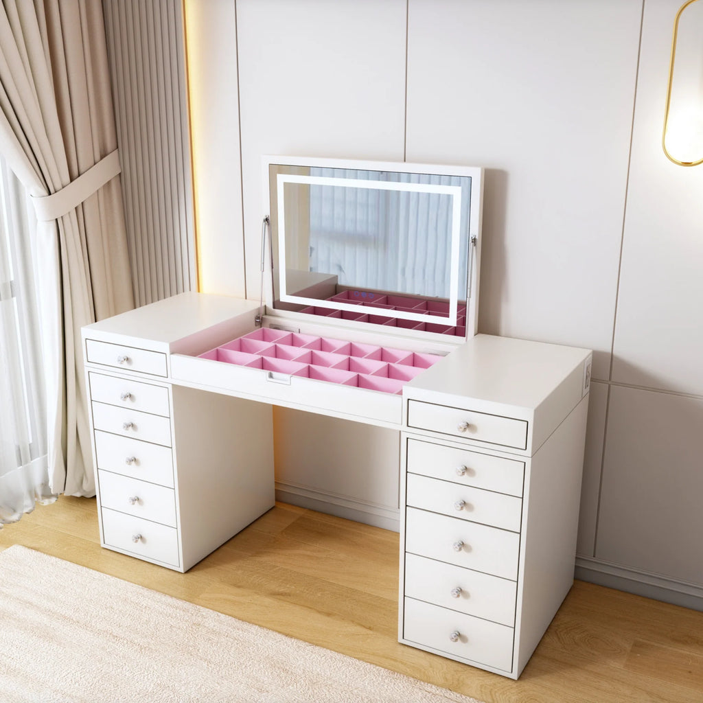 White vanity desk with mirror and pink makeup tray in a room with curtains and light fixture.