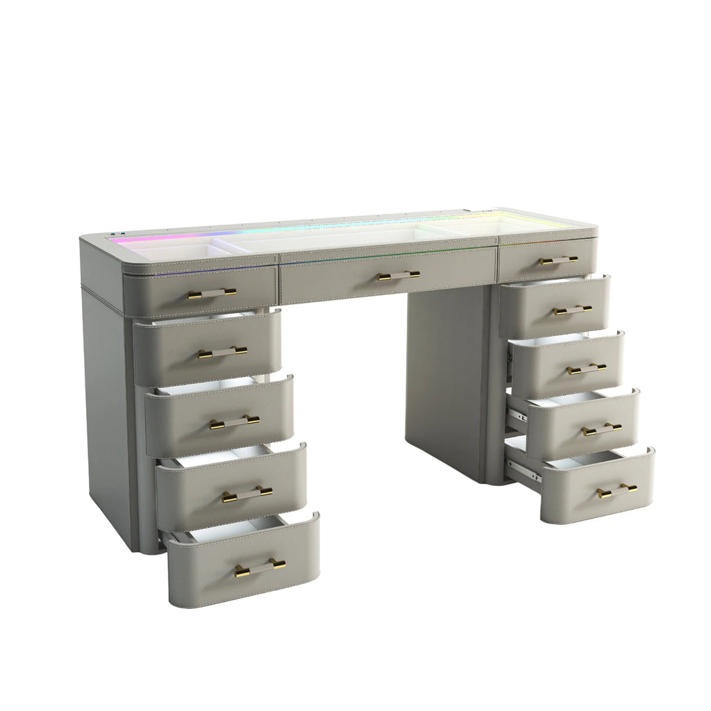 Modern light gray vanity desk with RGB LED glass top lighting, multiple soft-close drawers, gold hardware, and contemporary curved design with open drawers displayed.

