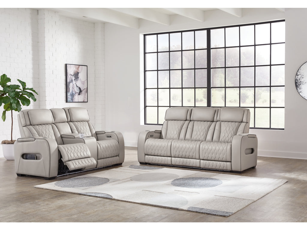 Gray recliner sofa set in a modern living room with large windows.