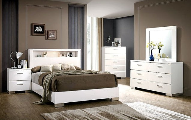 Modern bedroom set with white furniture, including a bed, nightstands, and dresser.
