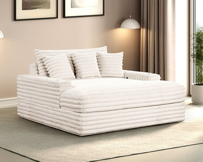 White corduroy sofa chaise with multiple cushions in a living room setting.
