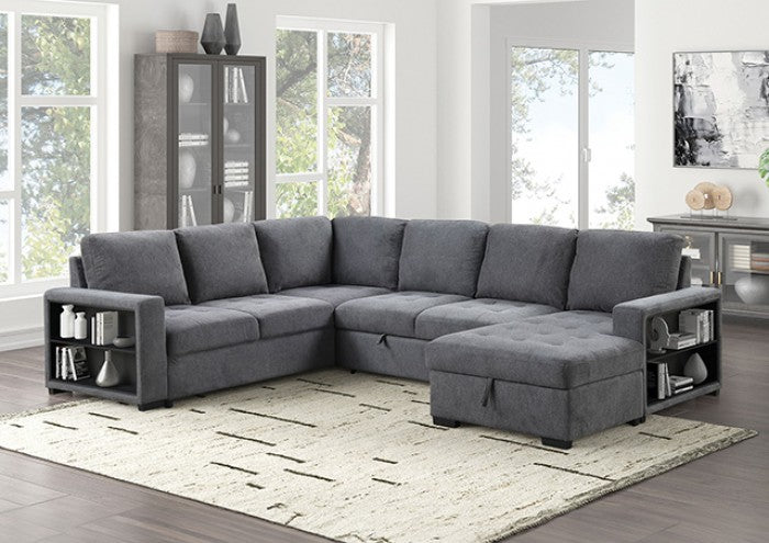 Gray sectional sofa in a living room setting with large windows and a rug.