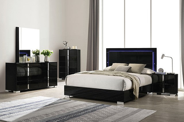 Modern bedroom set with black high-gloss furniture in a well-lit room.