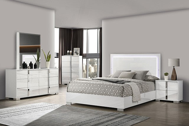 Modern bedroom with white furniture set including bed, dresser, and nightstands.