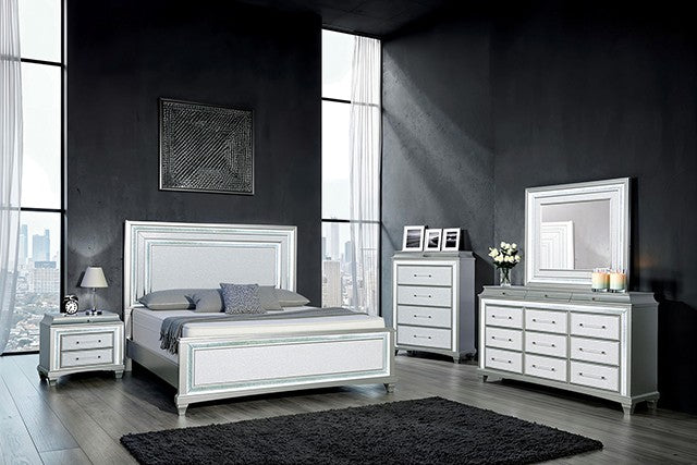 Modern bedroom set with white and silver furniture in a room with large windows.