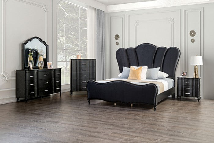 Modern bedroom with black upholstered bed and matching dressers.