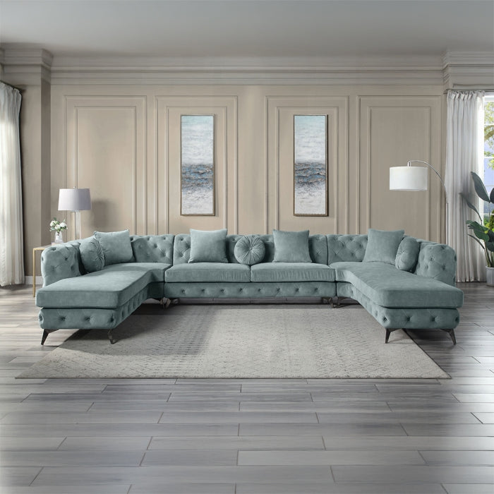 Tufted sectional sofa in a living room with neutral walls and decor.