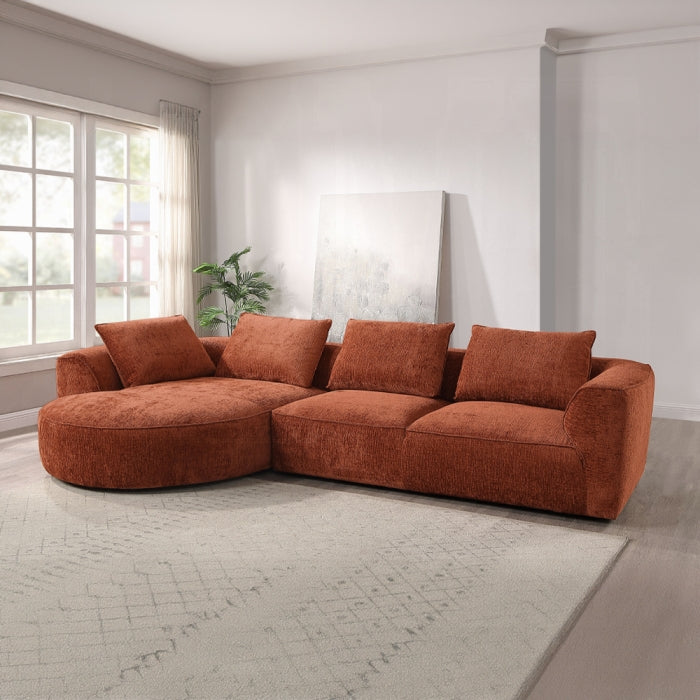 Brown sectional sofa in a modern living room with large windows.
