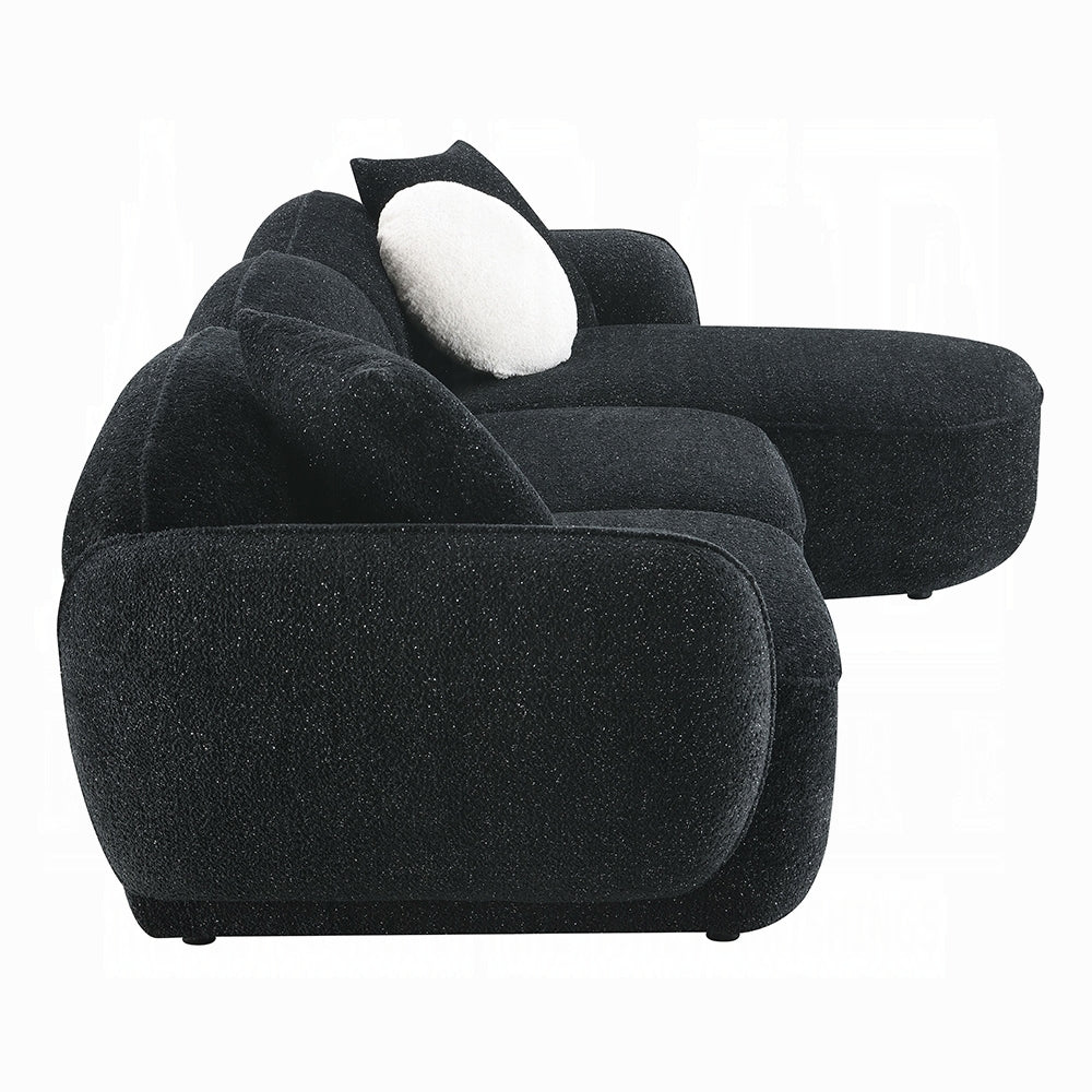 Black textured sofa with a white cushion on a white background