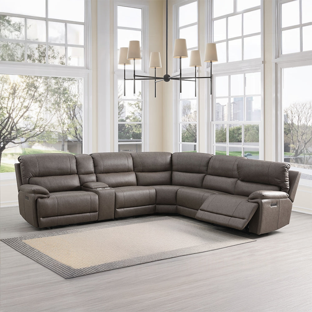 Gray sectional sofa in a modern living room with large windows.